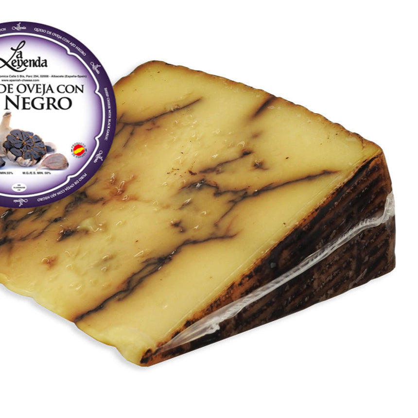 Block of black garlic goat cheese with Legendá label on a white background
